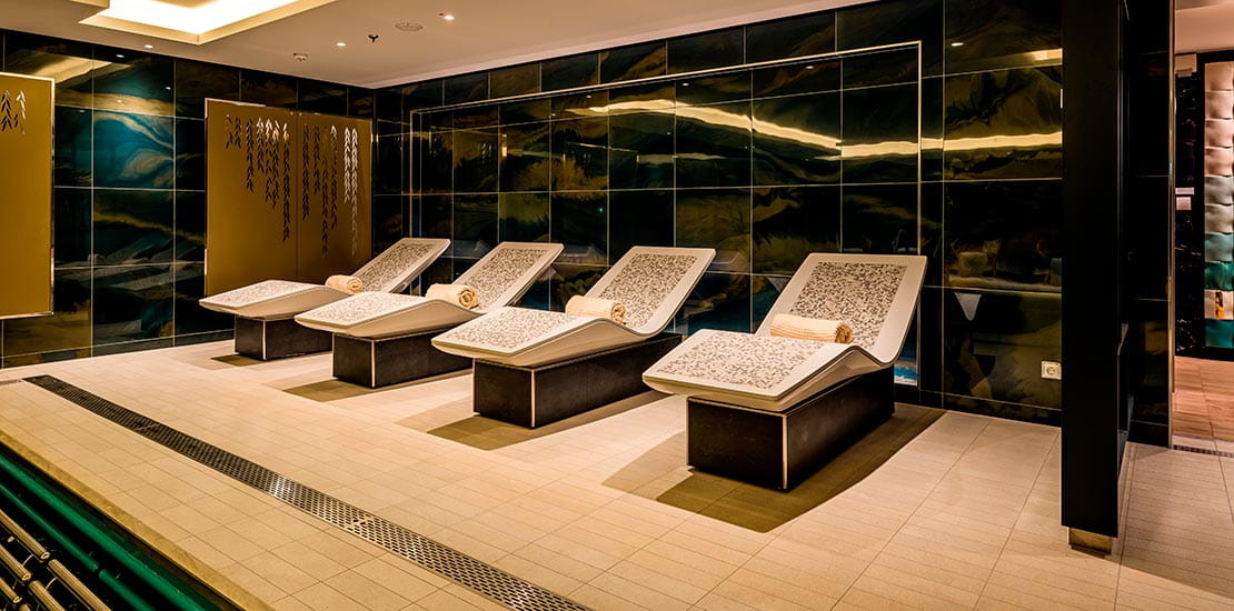 Relax on one of the thermal beds around the pool